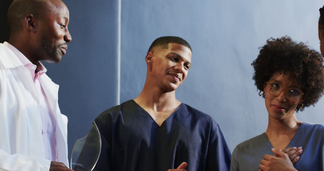 Proud Healthcare Team Applauding Success in Hospital Corridor