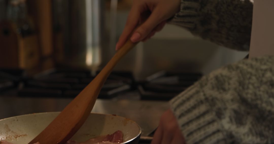 Person Cooking Bacon in Skillet with Wooden Spoon - Free Images, Stock Photos and Pictures on Pikwizard.com