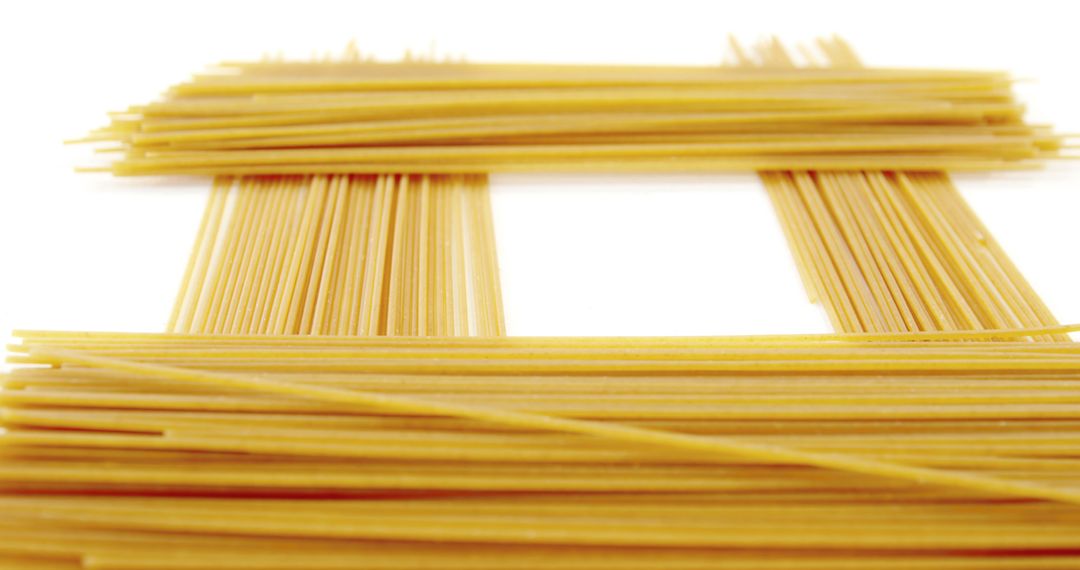 Uncooked Spaghetti Neatly Arranged Isolated on White Background - Free Images, Stock Photos and Pictures on Pikwizard.com