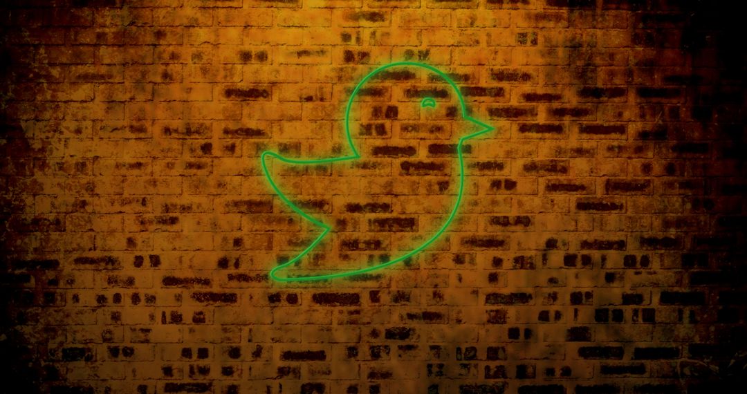 Neon Bird Icon on Brick Wall Reflecting Digital Communication