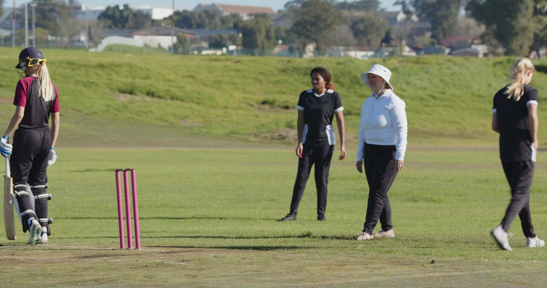 Women Engaging in Cricket Match Displaying Teamwork