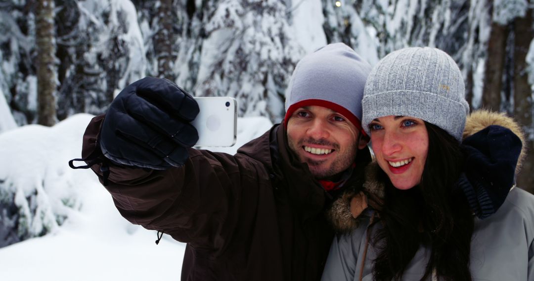 Couple Taking Selfie in Snowy Winter Forest - Free Images, Stock Photos and Pictures on Pikwizard.com