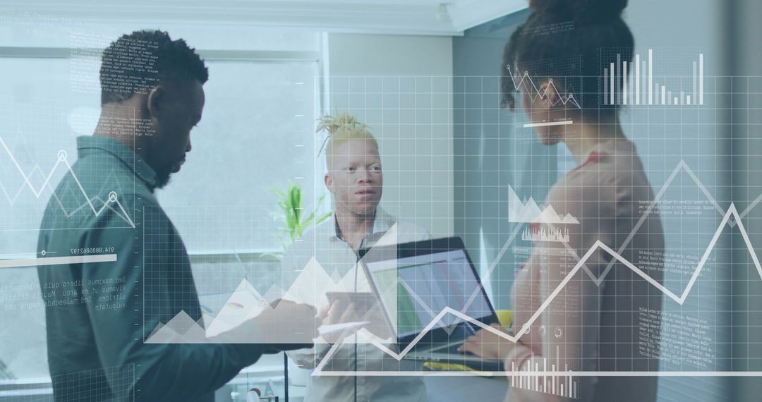 Diverse team analyzing data on laptop and tablet in sunlit modern glass office
