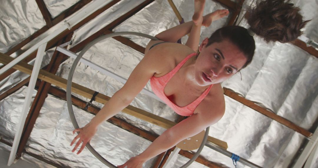 Female Acrobat Practicing Aerial Hoop in Industrial Setting - Free Images, Stock Photos and Pictures on Pikwizard.com