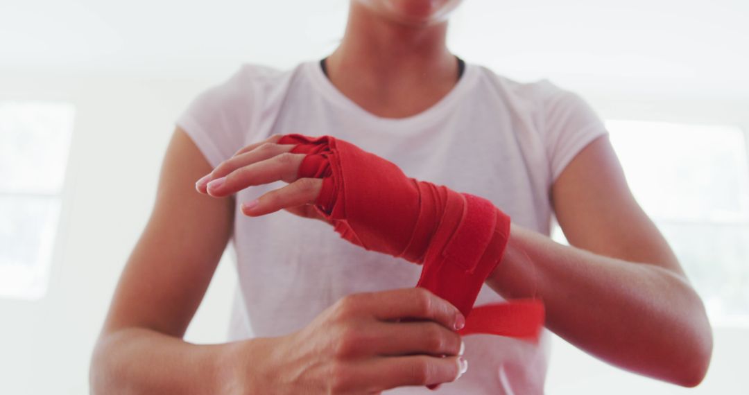 Woman Wrapping Hands with Red Boxing Hand Wraps for Training - Free Images, Stock Photos and Pictures on Pikwizard.com