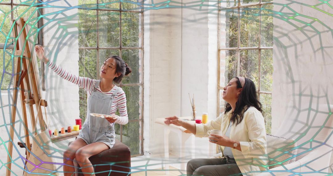 Sunlit art studio mentoring: young artist painting on easel while instructor guides