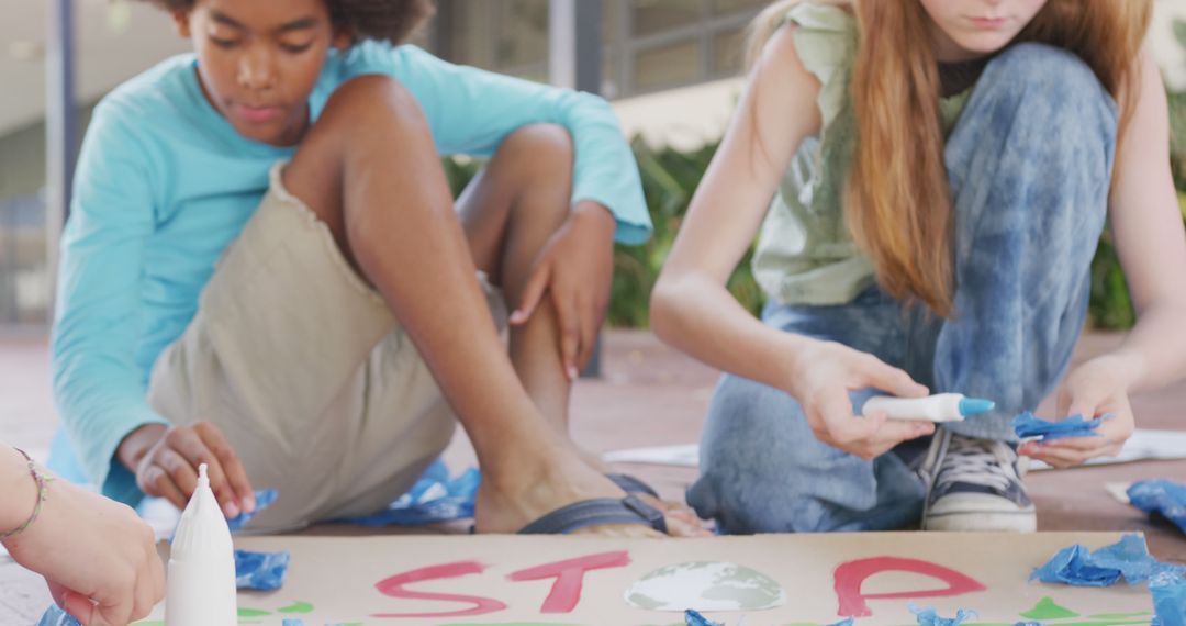 Children Making Environmental Activism Posters Outdoors - Free Images, Stock Photos and Pictures on Pikwizard.com