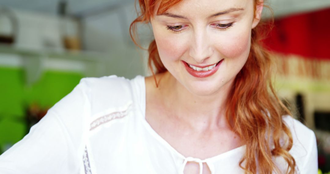 Smiling Redheaded Woman in Bright Kitchen Setting - Free Images, Stock Photos and Pictures on Pikwizard.com