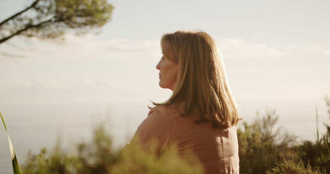 Thoughtful Senior Woman in Serene Countryside Setting - Free Images, Stock Photos and Pictures on Pikwizard.com