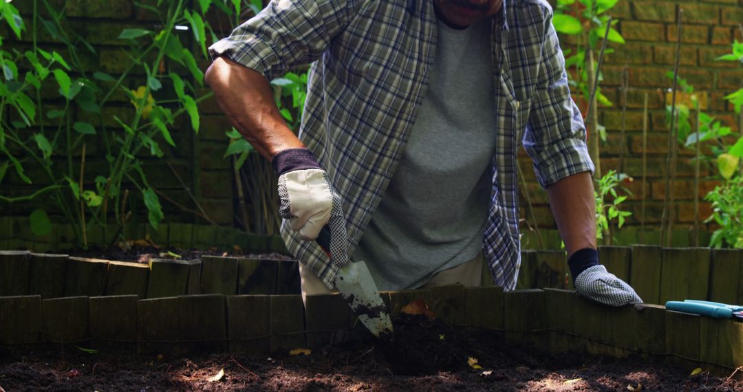 Mid-section of senior man digging in the soil with shovel - Free Images, Stock Photos and Pictures on Pikwizard.com