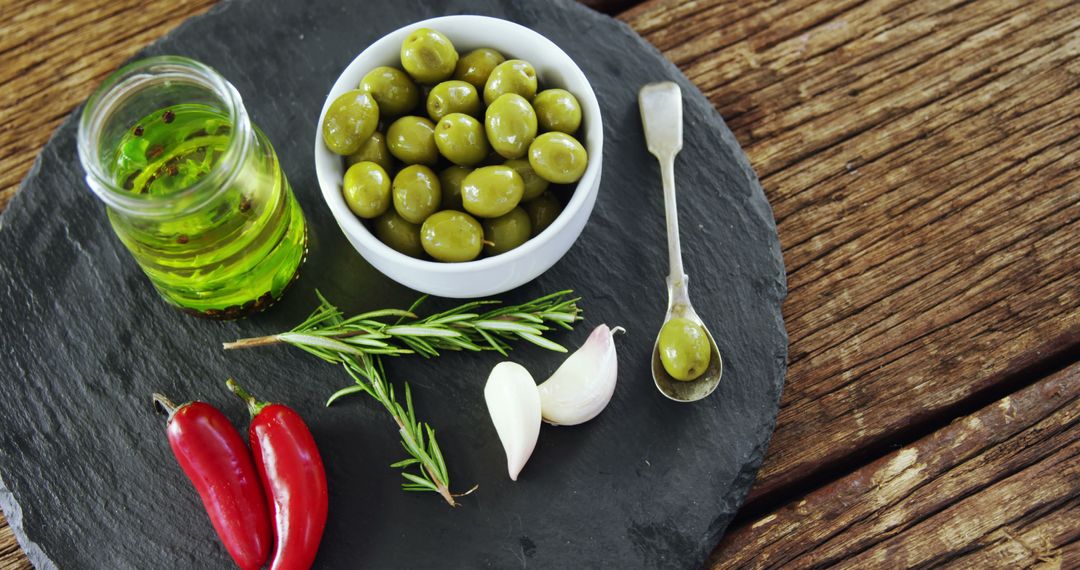 Mediterranean Green Olives with Herbs, Garlic, Olive Oil, and Red Chili Peppers - Free Images, Stock Photos and Pictures on Pikwizard.com