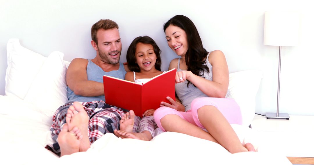 Happy Family Reading Book Together in Bed - Free Images, Stock Photos and Pictures on Pikwizard.com