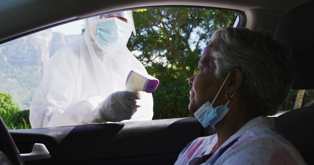 Healthcare Worker Taking Temperature of Elderly Woman in Drive-through - Free Images, Stock Photos and Pictures on Pikwizard.com