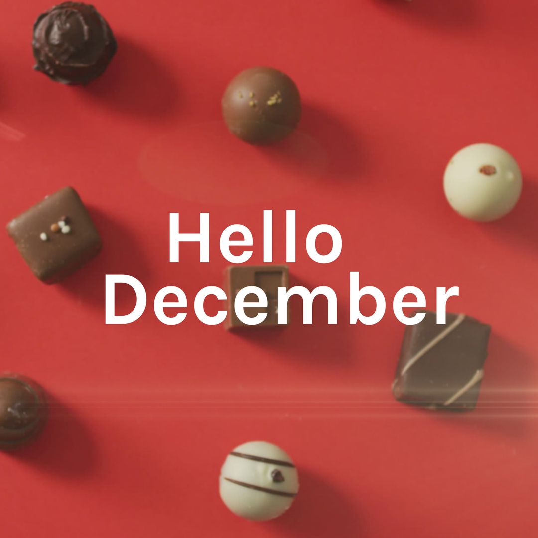 December Greeting with Chocolates on Red Background