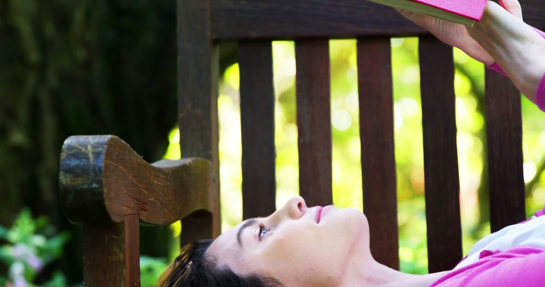 Woman Relaxing on Wooden Bench Reading in Garden - Free Images, Stock Photos and Pictures on Pikwizard.com