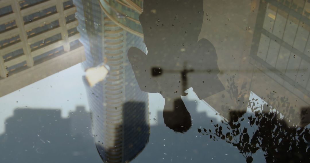 Puddle Reflection Showcasing Urban Architecture and Nature