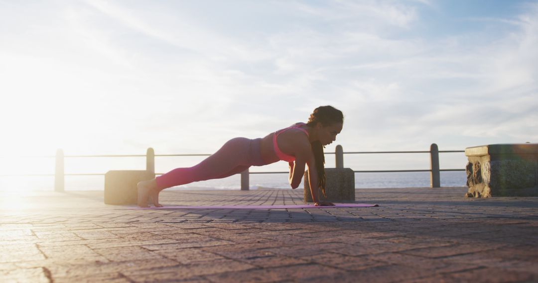 Young Woman Performing Outdoor Yoga at Sunrise on Seaside Walkway - Free Images, Stock Photos and Pictures on Pikwizard.com