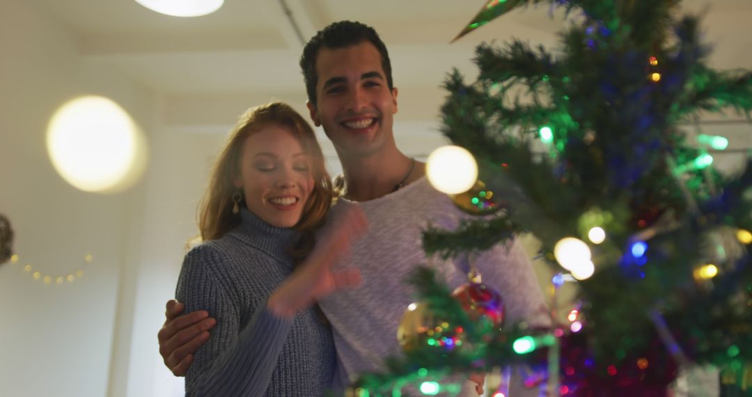 Happy Couple Decorating Christmas Tree Together Indoors - Free Images, Stock Photos and Pictures on Pikwizard.com