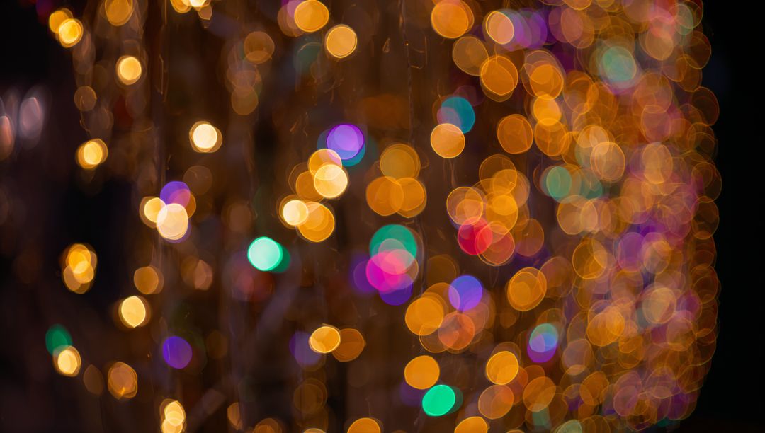 Golden Bokeh Curtain of Multicolor Festive Lights Creating Soft Glowing Orbs Background