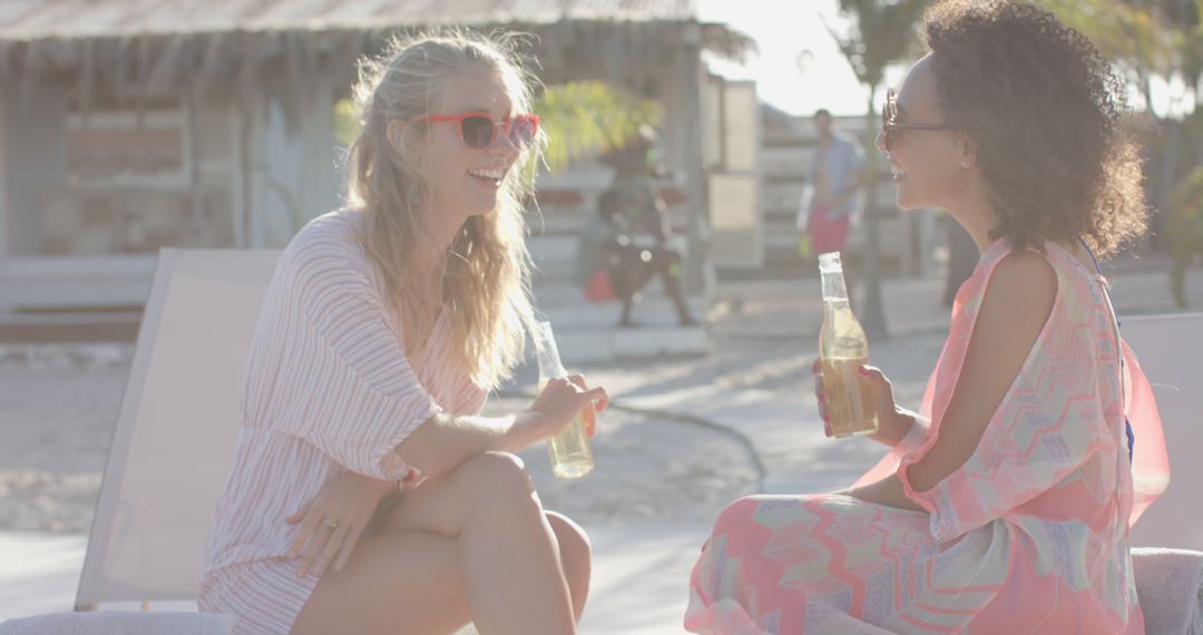 Two Women Enjoying Drinks at Beach Resort - Free Images, Stock Photos and Pictures on Pikwizard.com