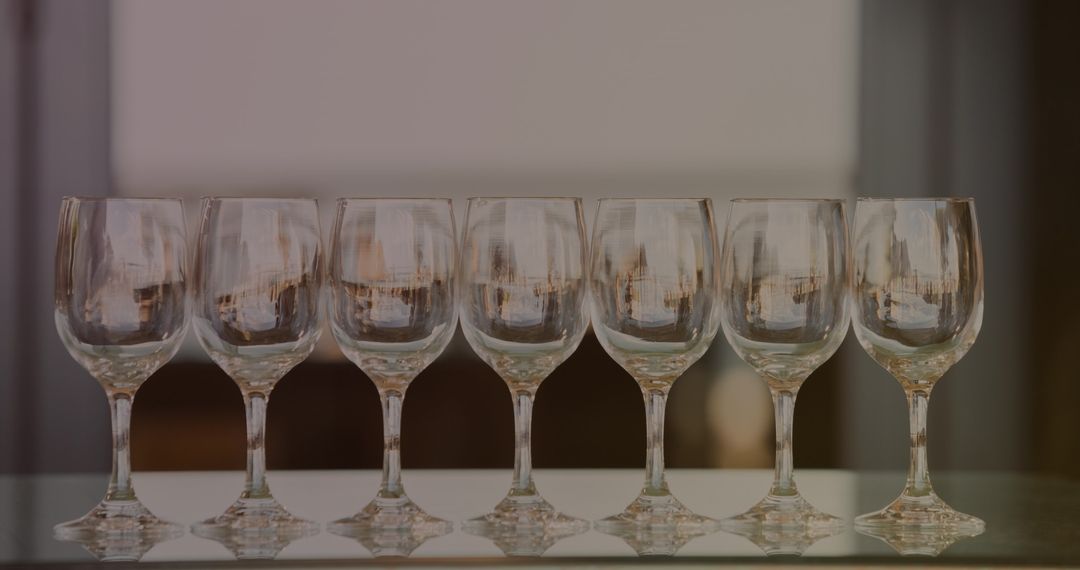 Seven Empty Wine Glasses with Golden Reflections Eliciting Elegance and Sophistication