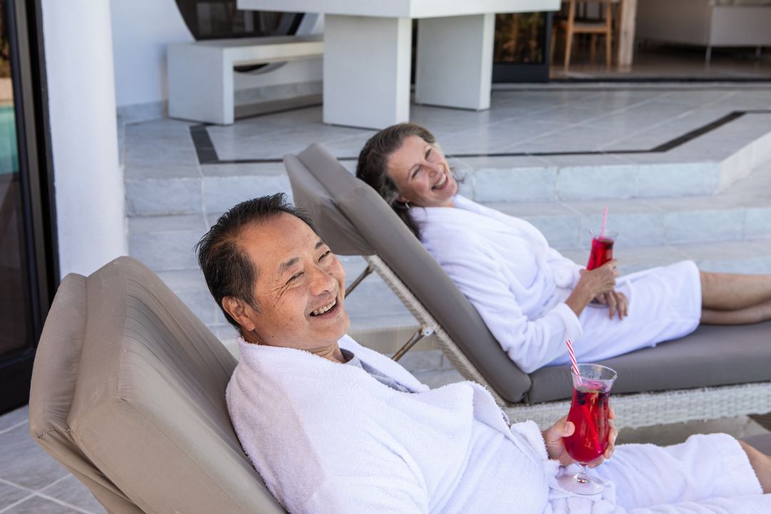 Senior Asian Couple Relaxing with Drinks on Patio