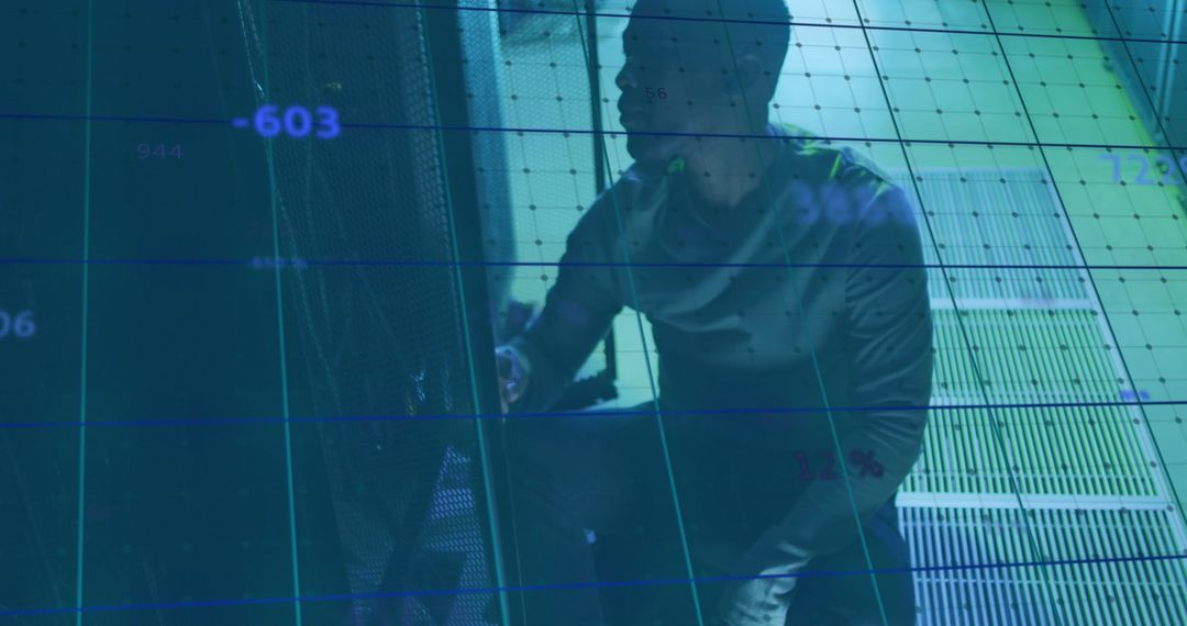 African American IT Technician Analyzing Server Data Overlay