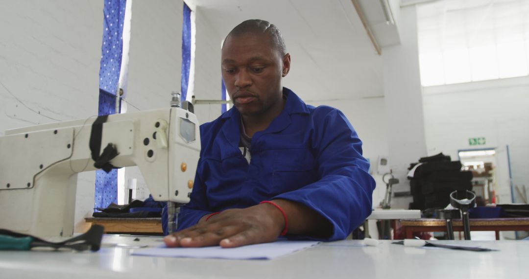 Worker Sewing in Wheelchair Factory Workshop