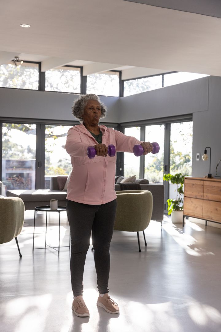 Senior Woman Engaging in Strength Training With Dumbbells at Home