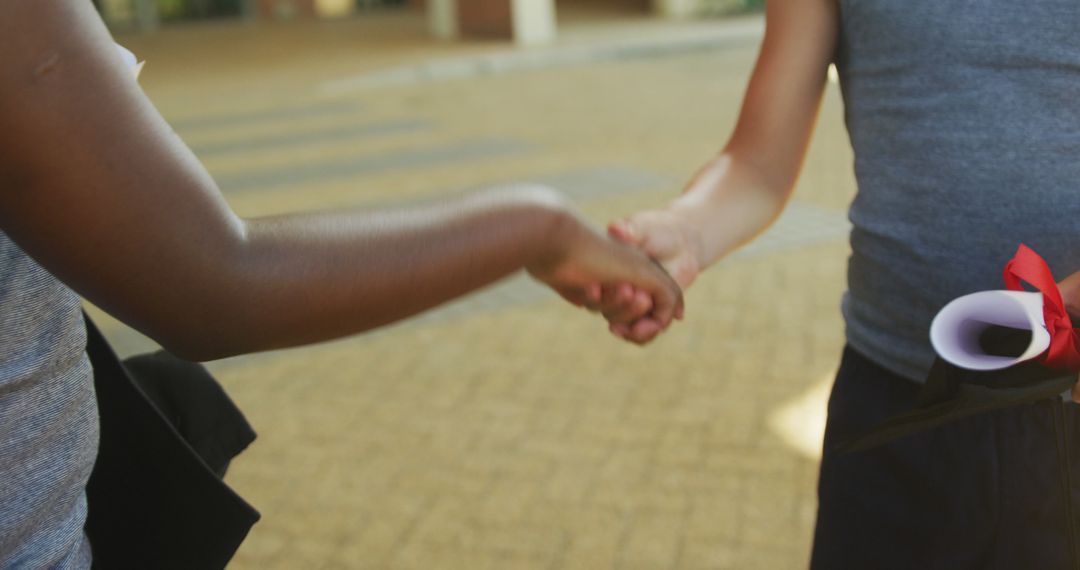 Handshake Between Two People Congratulating Each Other at Graduation - Free Images, Stock Photos and Pictures on Pikwizard.com