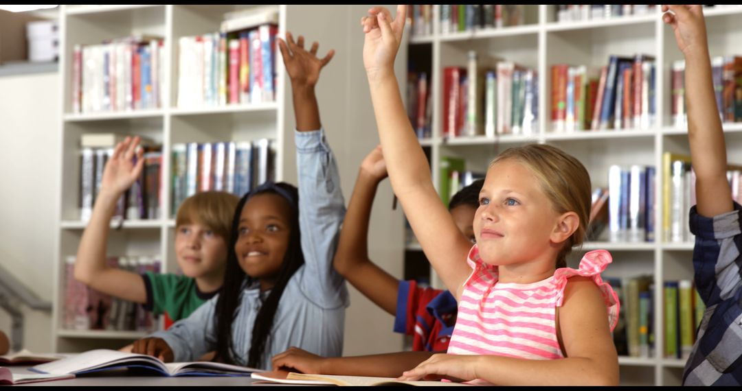 Diverse Group of Children Raising Hands in Classroom Library - Free Images, Stock Photos and Pictures on Pikwizard.com