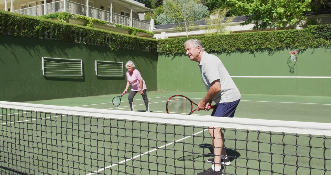 Happy Caucasian Senior Couple Playing Doubles Tennis on Outdoor Court - Free Images, Stock Photos and Pictures on Pikwizard.com