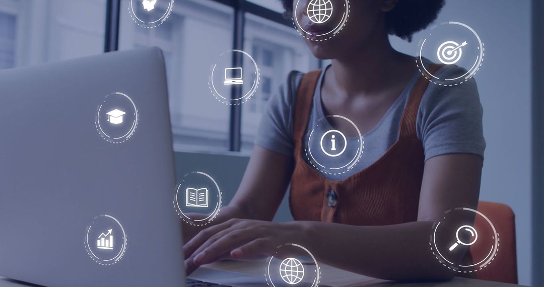African American Businesswoman Using Laptop with Digital Data Icons Overlay