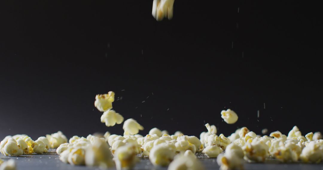 Popcorn Falling with Black Background Highlighting Freshness