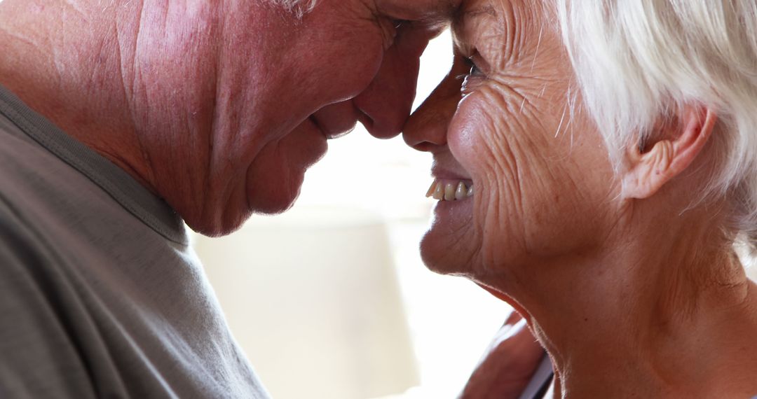 Happy Elderly Couple Embracing and Smiling with Joy - Free Images, Stock Photos and Pictures on Pikwizard.com