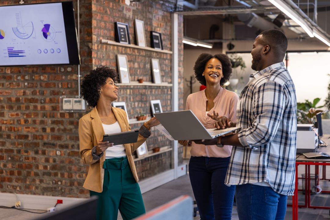 Diverse Coworkers Engaging in Project Discussion in Open-plan Office