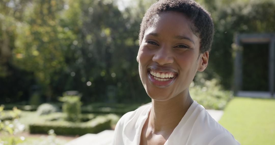 Smiling African American Woman Enjoying Sunny Day in Garden - Free Images, Stock Photos and Pictures on Pikwizard.com