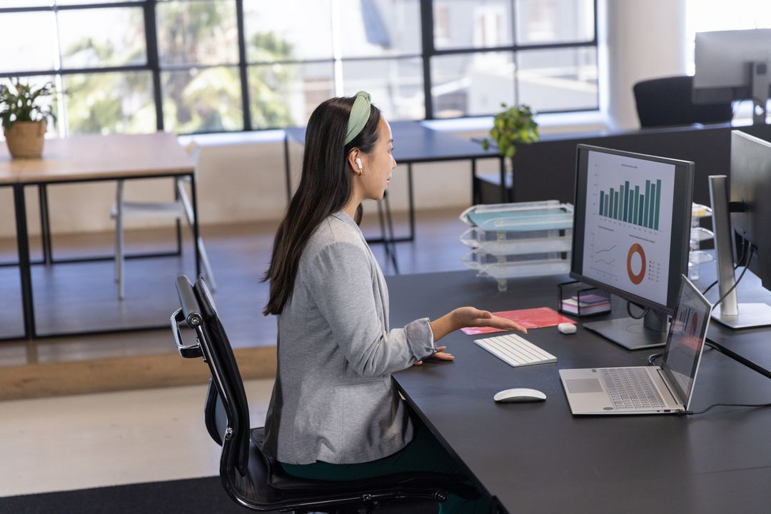 Professional Modern Office with Charts on Screen