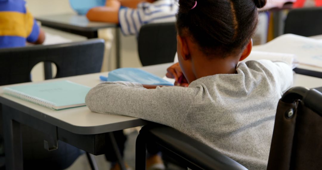 Disabled African American Schoolgirl Learning in Classroom