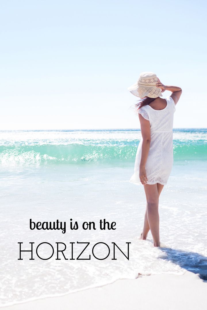 Woman in White Dress Enjoys Tranquil Ocean Views