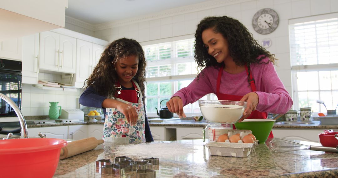 Young Biracial Woman and Girl Baking Together in Bright Kitchen Sharing Joyful Moment - Free Images, Stock Photos and Pictures on Pikwizard.com