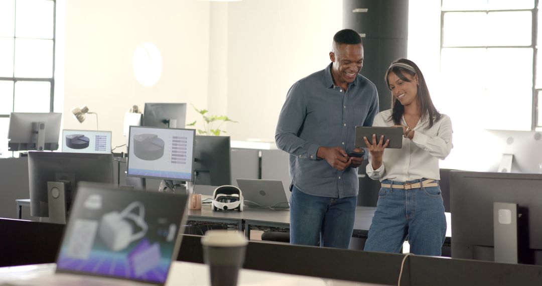 Office Collaboration with Colleagues Discussing Projects on Tablet