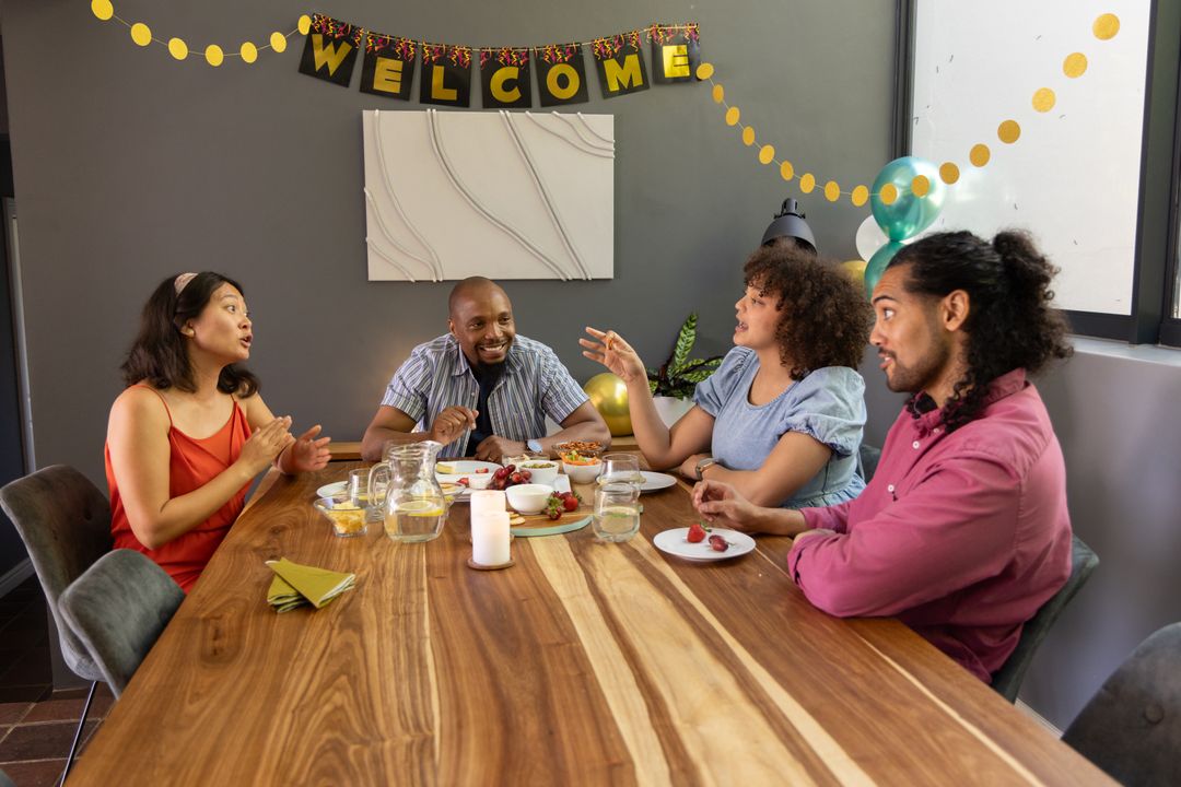 Diverse Coworkers Celebrating Around Wooden Table in Meeting Room