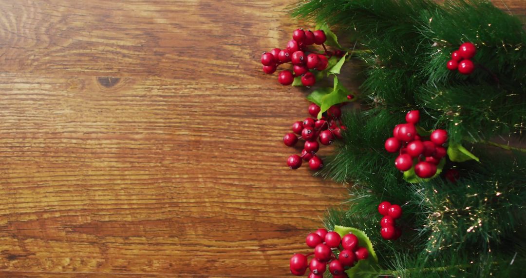 Festive Christmas Garland with Red Berries on Wooden Background