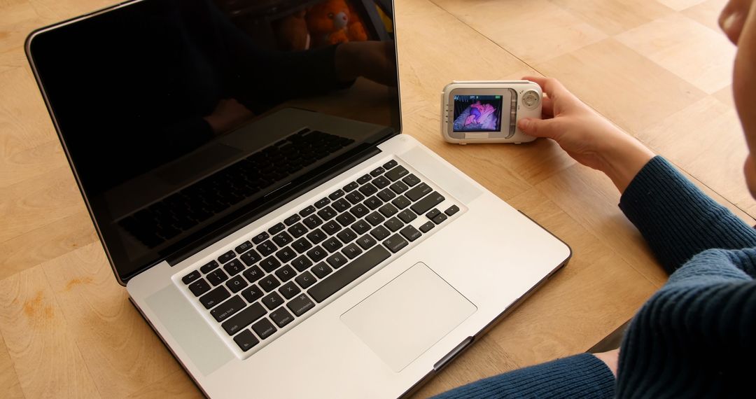 Person using baby monitor while working on laptop - Free Images, Stock Photos and Pictures on Pikwizard.com