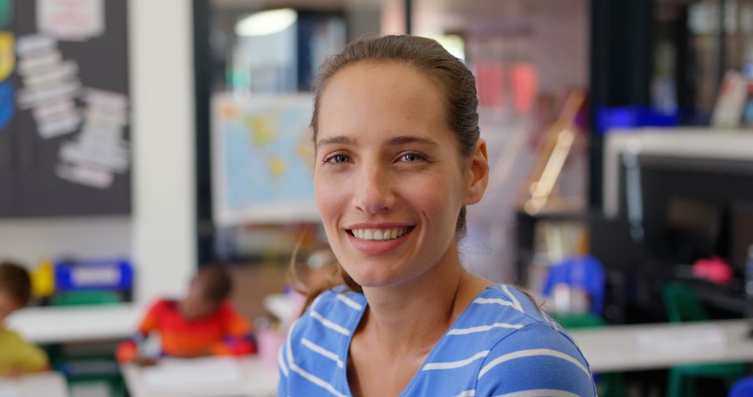 Smiling Female Teacher in Classroom with Schoolchildren Studying Happily
