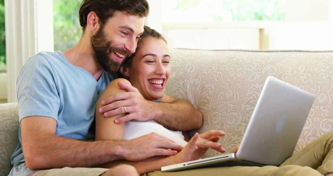 Happy Couple Relaxing and Enjoying Laptop Time at Home