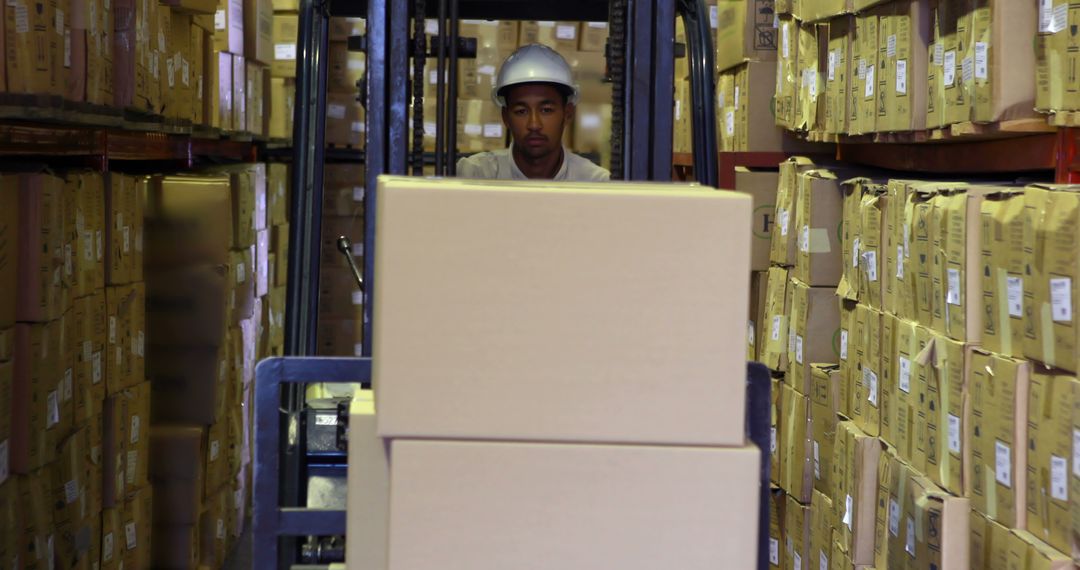 Warehouse Worker Operating Forklift with Cardboard Boxes - Free Images, Stock Photos and Pictures on Pikwizard.com