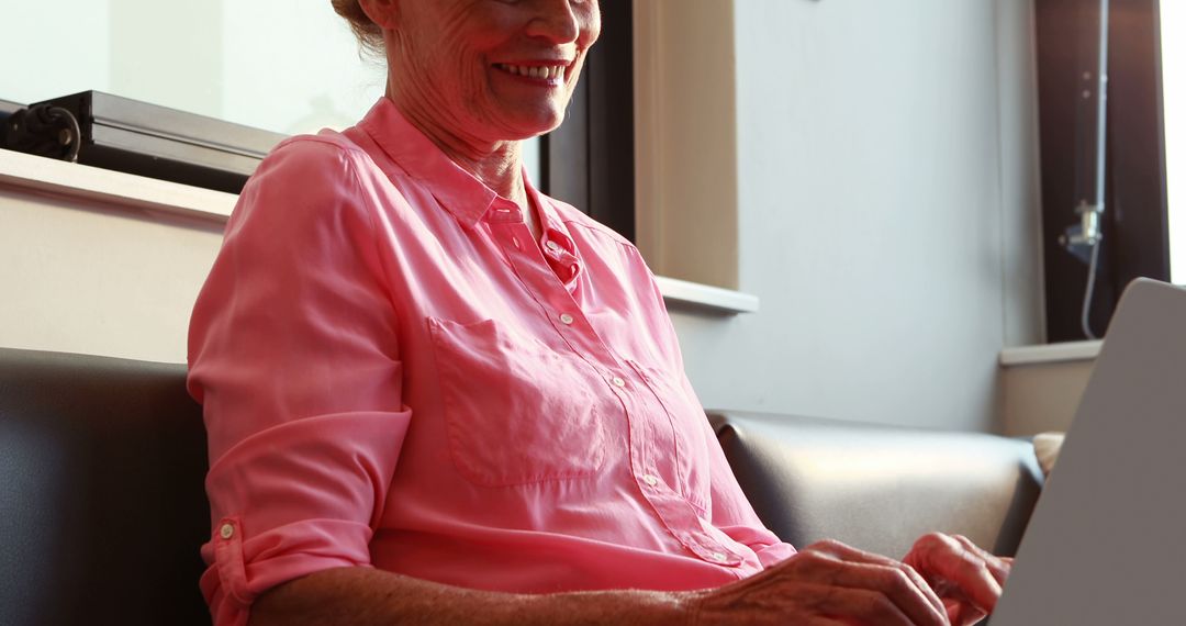 Elderly Woman Smiling While Using Laptop - Free Images, Stock Photos and Pictures on Pikwizard.com