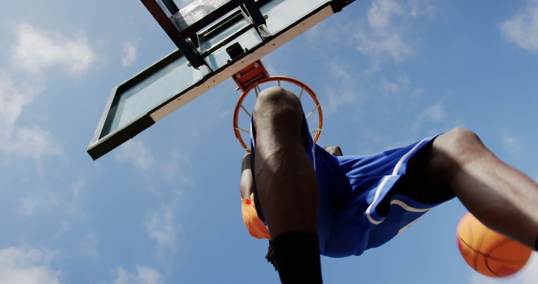 Low Angle View of Female Basketball Player Dunking Ball - Free Images, Stock Photos and Pictures on Pikwizard.com